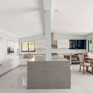 Your sleek modern kitchen flows seamlessly into the dining area, creating the perfect space for cooking together and sharing memorable meals.