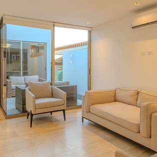 Sink into plush seating while enjoying seamless indoor-outdoor flow through floor-to-ceiling glass doors to your private terrace.