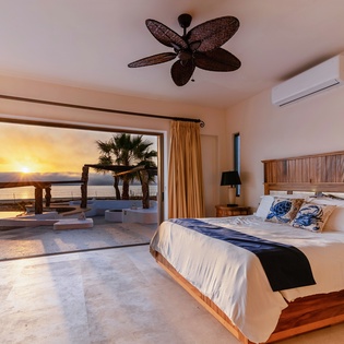 Bedroom suite with patio access and ocean views