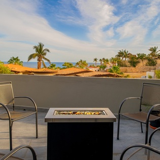 Gather around the fire pit on your private terrace, where ocean breezes and tropical views create the perfect evening retreat.