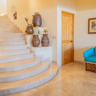 You'll love the warm, artistic touches throughout—handcrafted pottery and vibrant tropical flowers create an inviting atmosphere in your beautiful vacation retreat.