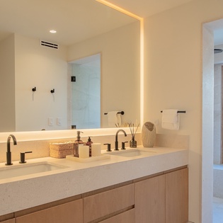 En suite bathroom with double sink and walk in shower