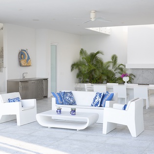 Relax in your bright, modern living space with crisp white furnishings and pops of blue accents.