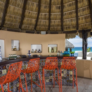 Sip tropical cocktails at your private thatched-roof bar while ocean breezes and stunning sea views create the perfect backdrop for relaxation.