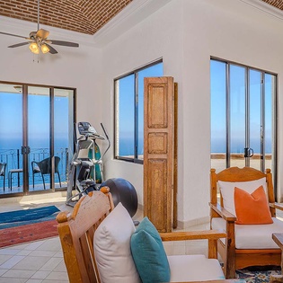 Your private fitness area invites morning workouts surrounded by sweeping ocean panoramas. Step outside to the terrace and feel the coastal breeze after your session.