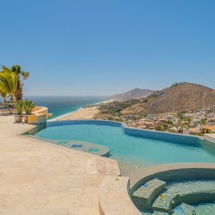 Stunning infinity pool with panoramic ocean and mountain views creating the perfect backdrop for your vacation relaxation.
