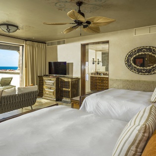 Wake up to stunning ocean views from your spacious bedroom featuring twin beds and elegant furnishings.