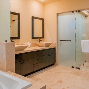En-suite bathroom with bathtub and walk-in shower