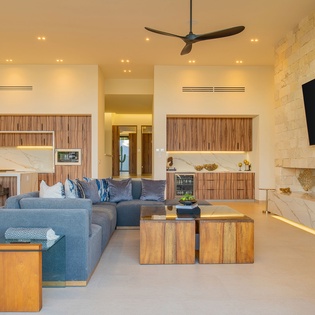 Sink into plush seating while flames dance in your modern fireplace. The open kitchen beckons for cooking adventures in this luxurious retreat.