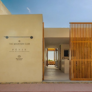 Modern entrance to The Mountain Club Fénix with warm Mediterranean architecture and contemporary design.