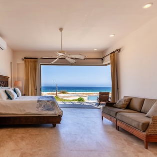 Bedroom suite with patio access and ocean views