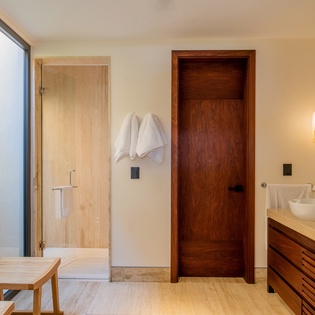 En suite bathroom with double sink and walk in shower