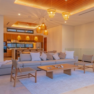 Unwind in your stunning open-plan living space, where warm wood accents and contemporary design create the perfect atmosphere for relaxation.