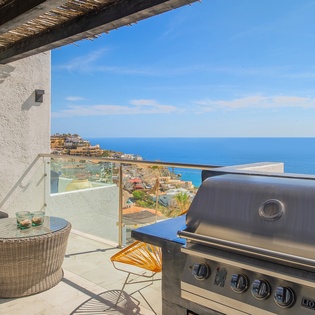 BBQ area with outdoor seating and ocean views