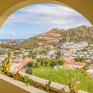 Arch window frame with city and ocean view