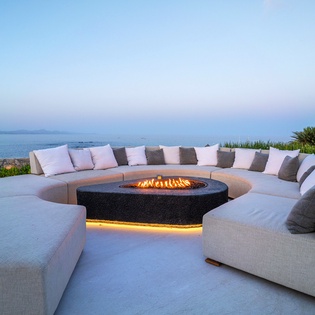 Fire pit surround by the infinity pool and ocean views