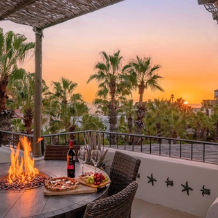 Outdoor dining with firepit over looking a gorgeous sunset view