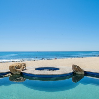 Lounge by the poolside with ocean views