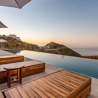 Stunning infinity pool terrace with panoramic ocean and mountain views, creating the perfect backdrop for your Mediterranean escape.