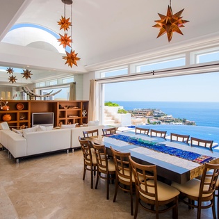 Living and dining room with access to patio and ocean view