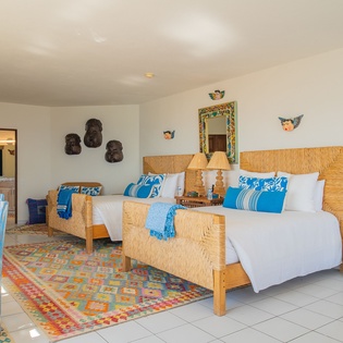 Unwind in your beautifully appointed bedroom with twin beds, vibrant Mexican décor, and authentic touches that make you feel at home.