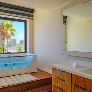 En suite bathroom with bathtub and ocean views