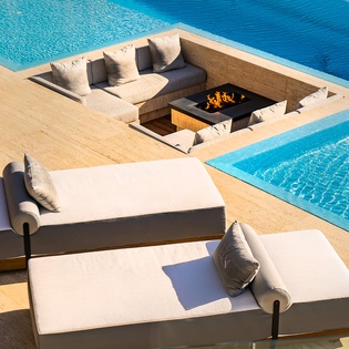 Patio with infinity pool and built-in seating area