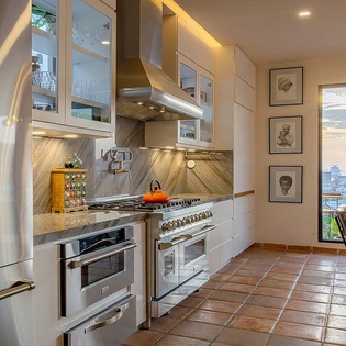 Your modern kitchen features stainless steel appliances, sleek white cabinetry with under-cabinet lighting, and a professional-grade gas range—perfect for creating memorable meals during your stay.