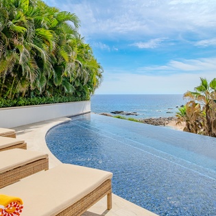 Swim in your private infinity pool while palm trees sway and endless ocean views stretch to the horizon.