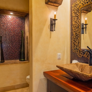 Step into your private retreat with handcrafted stone basin, intricate mosaic details, and rustic wood touches creating pure tranquility.