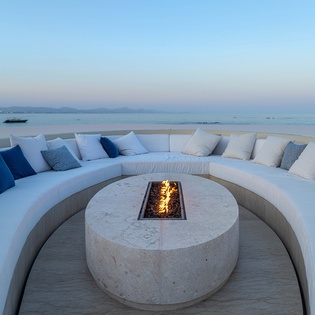 Fire pit surround by the infinity pool and ocean views
