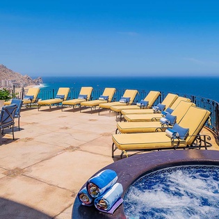 Soak in the bubbling hot tub while gazing at endless ocean views, then unwind on cushioned sun loungers as warm breezes sweep across your private terrace.
