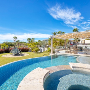 Sunny patio with pool and jacuzzi