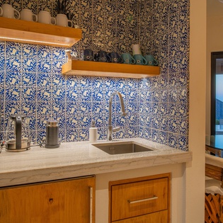 Your private kitchenette features stunning handcrafted blue tiles, modern appliances, and everything you need to prepare meals while enjoying gorgeous ocean views.