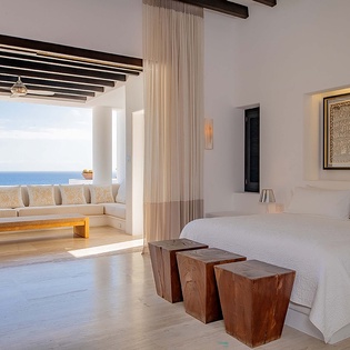 Wake up to endless ocean views from your serene bedroom suite. Floor-to-ceiling windows frame the azure sea, while modern design and natural wood accents create a peaceful retreat where relaxation comes naturally.