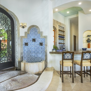 Step into your elegant Mediterranean-style kitchen where stunning blue tilework and arched details create a sophisticated dining experience.