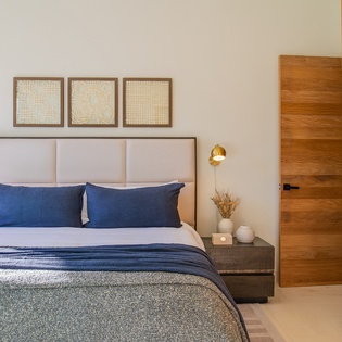 Unwind in your serene bedroom with crisp linens, thoughtful artwork, and warm wood accents creating the perfect retreat.