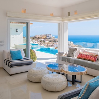 Living area with ocean views and patio access