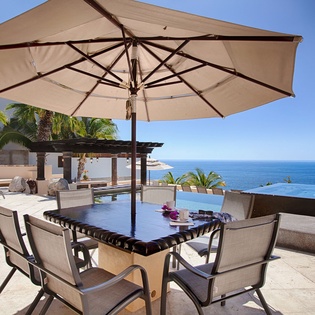 Stunning oceanfront terrace with infinity pool, shaded dining for six, and breathtaking sea views where your mornings begin with coffee overlooking endless blue horizons.