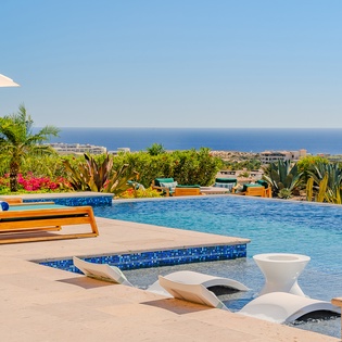 Dive into paradise at your private pool with sweeping sea views and desert garden backdrop.