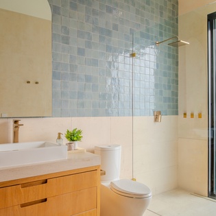 Step into your spa-like bathroom with gorgeous blue mosaic tiles, modern fixtures, and a refreshing walk-in shower that makes every morning feel luxurious.