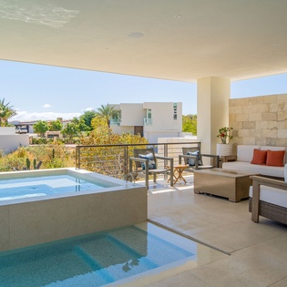 Step onto your private covered terrace where luxury meets relaxation—your own plunge pool awaits alongside elegant seating for the perfect retreat.