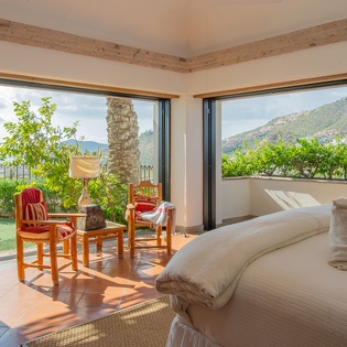Bedroom suite with outdoor garden access and seating