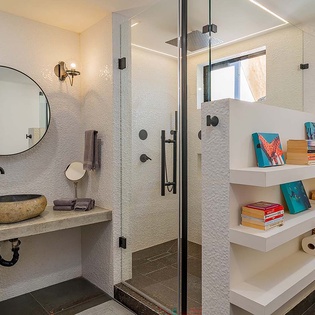 Step into your private sanctuary featuring a rainfall shower, elegant stone basin, and built-in shelving—all bathed in natural light for a luxurious, refreshing escape.