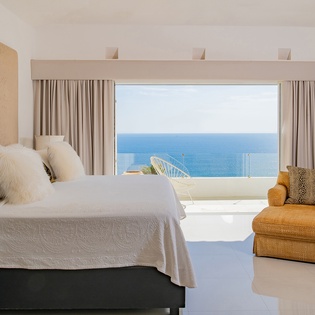 Bedroom suite with terrace and patio access and ocean views
