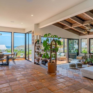 Bright open-plan living with breathtaking views, warm wood beams, and terracotta tiles. Step outside to your private terrace and soak in the coastal hills from every angle.