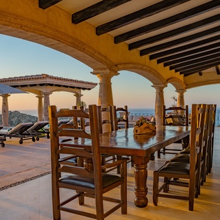 Enjoy memorable meals at this stunning covered terrace with sea views and elegant archways.