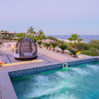Poolside with ocean views at dusk