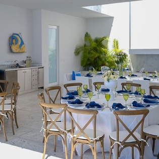 Host memorable gatherings on your spacious rooftop terrace with elegant table settings and tropical greenery creating the perfect backdrop.