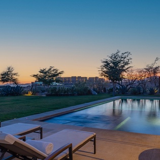 Poolside patio with ocean view during sunset